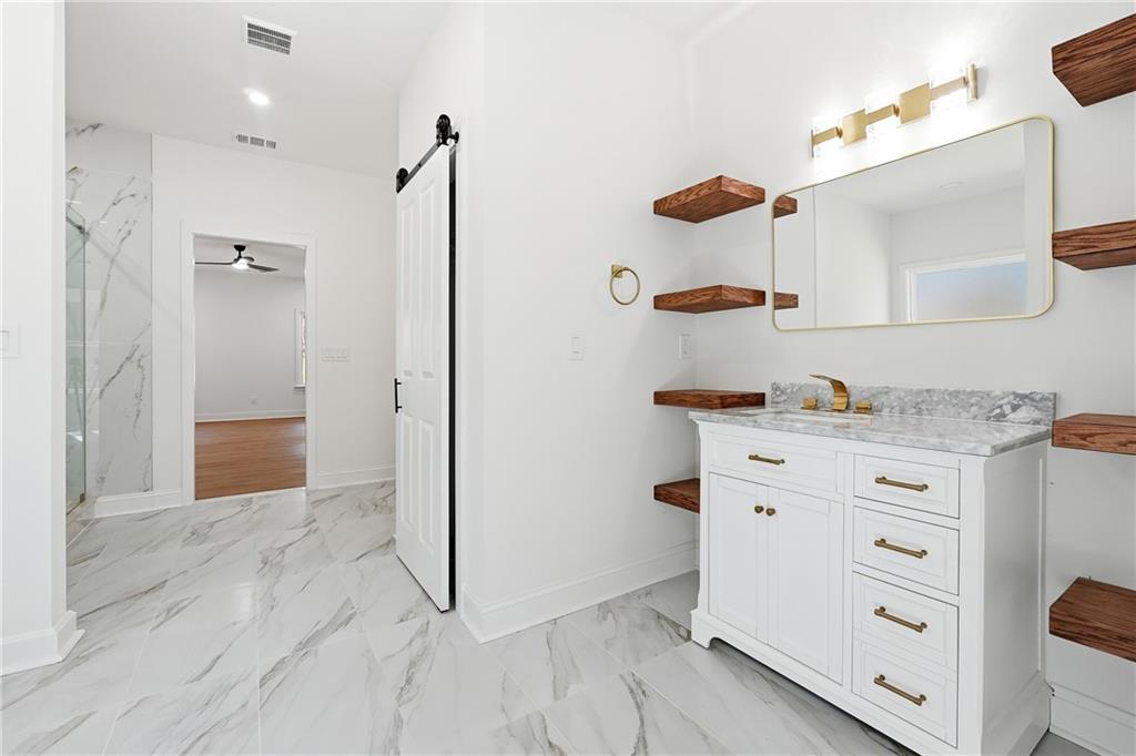 644 Hampton Road Hampton, GA 30228 - Photo 27 of 40 a bathroom with a granite countertop sink mirror and shower