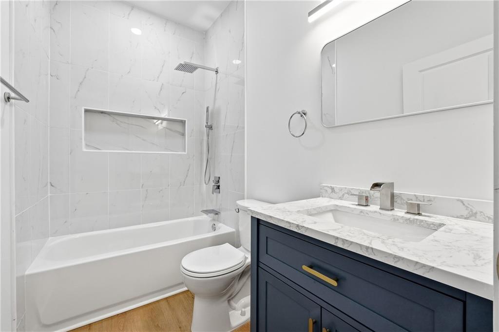 644 Hampton Road Hampton, GA 30228 - Photo 29 of 40 a bathroom with a granite countertop sink a toilet and shower