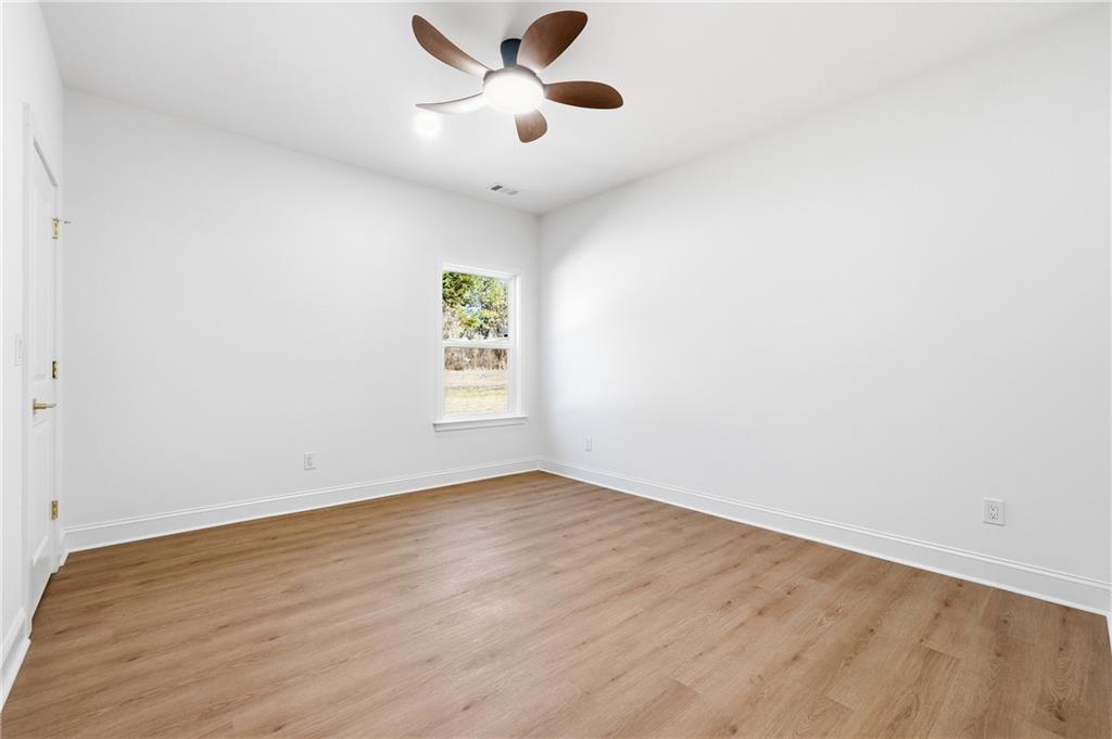 644 Hampton Road Hampton, GA 30228 - Photo 30 of 40 an empty room with wooden floor and windows