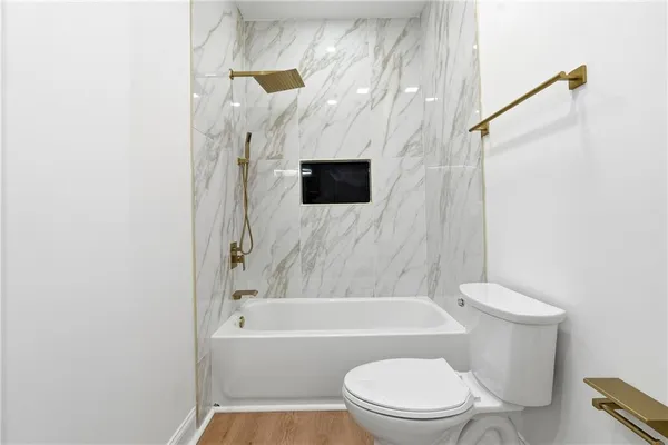 a bathroom with a toilet and a bathtub