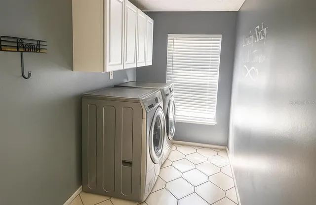 a utility room with a sink dryer and washer