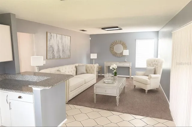 a living room with furniture and a large window