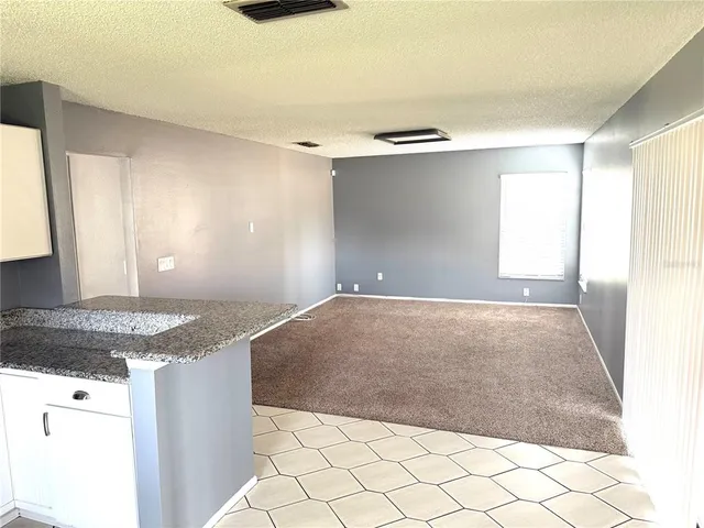 a kitchen with granite countertop a sink and a stove