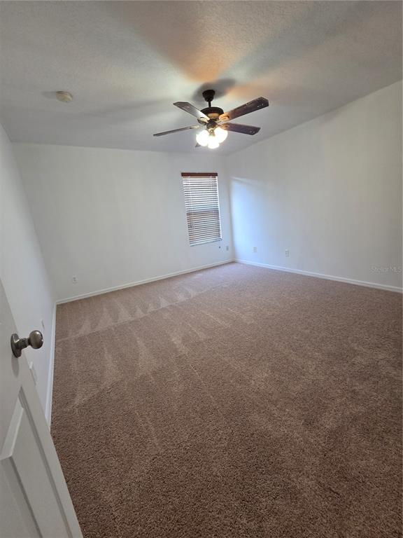 2400 Tybee Road St. Cloud, FL 34769 - Photo 4 of 15 a view of a room with a ceiling fan and a chandelier fan