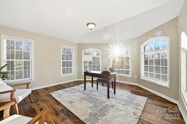 a view of a livingroom with furniture window and wooden floor