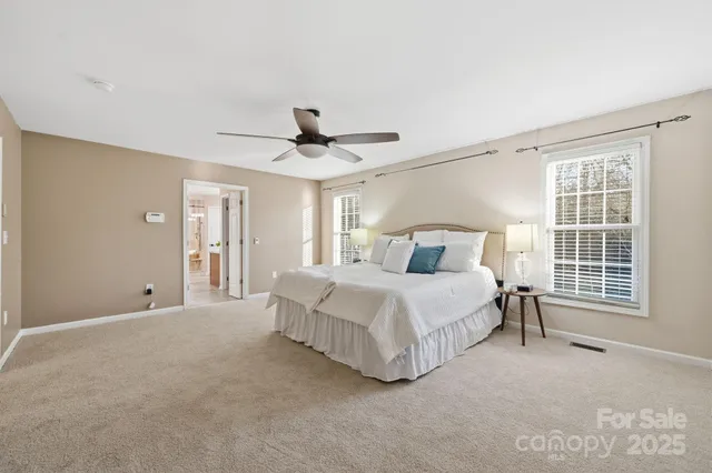 a bedroom with a large bed and a window