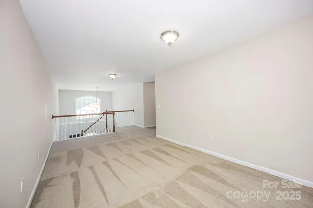a view of a room with window and a ceiling fan