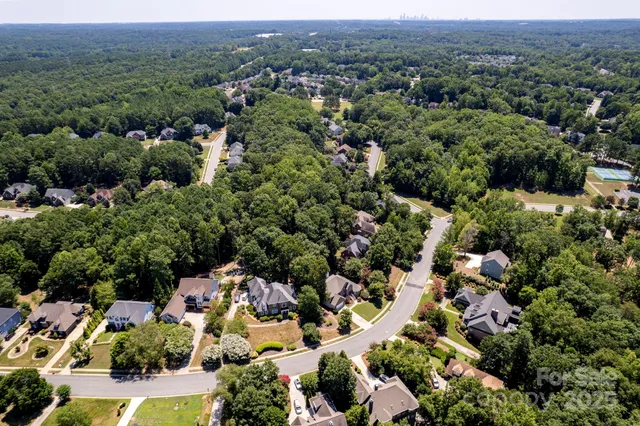 an aerial view of a houses with a lake view