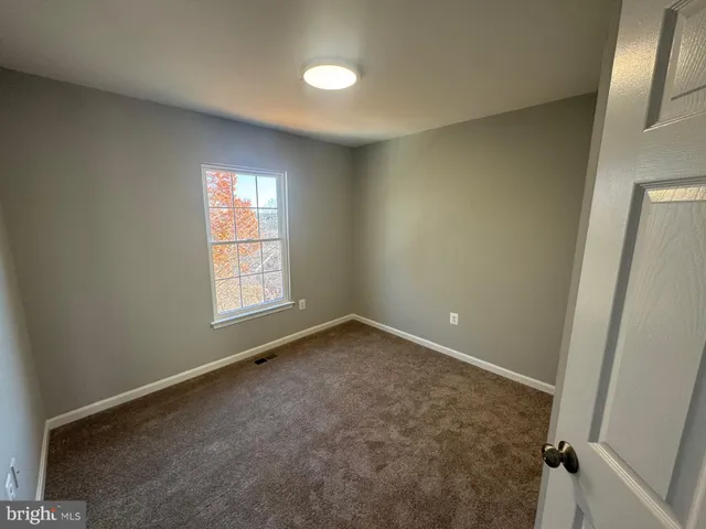 an empty room with a empty space and windows