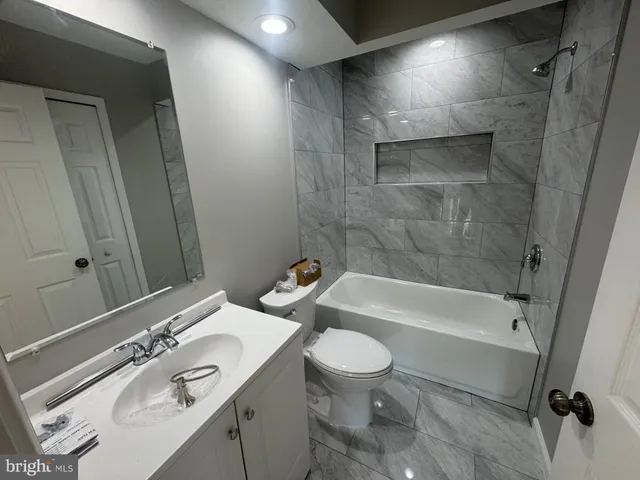 a bathroom with a sink a toilet and a bathtub