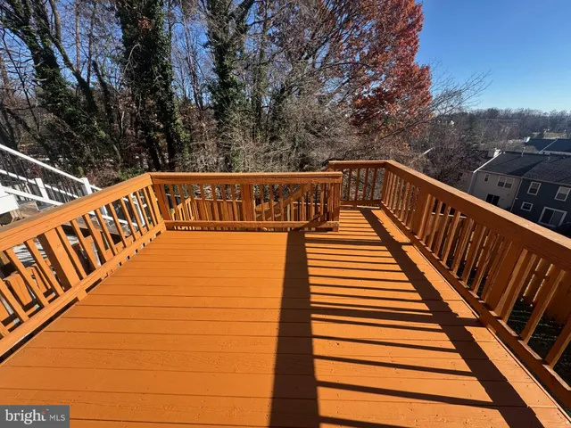 a view of balcony with wooden floor and fence