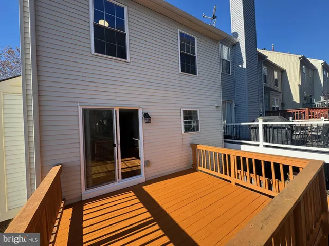 a view of a balcony with wooden floor and fence
