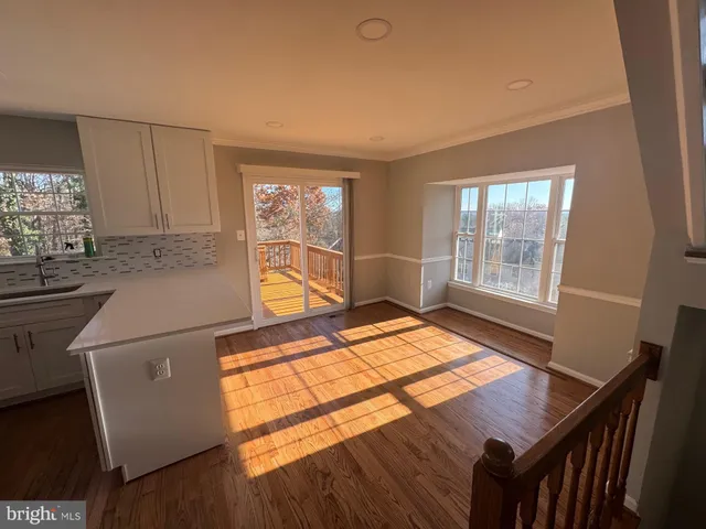 a bed sitting in a room next to a window