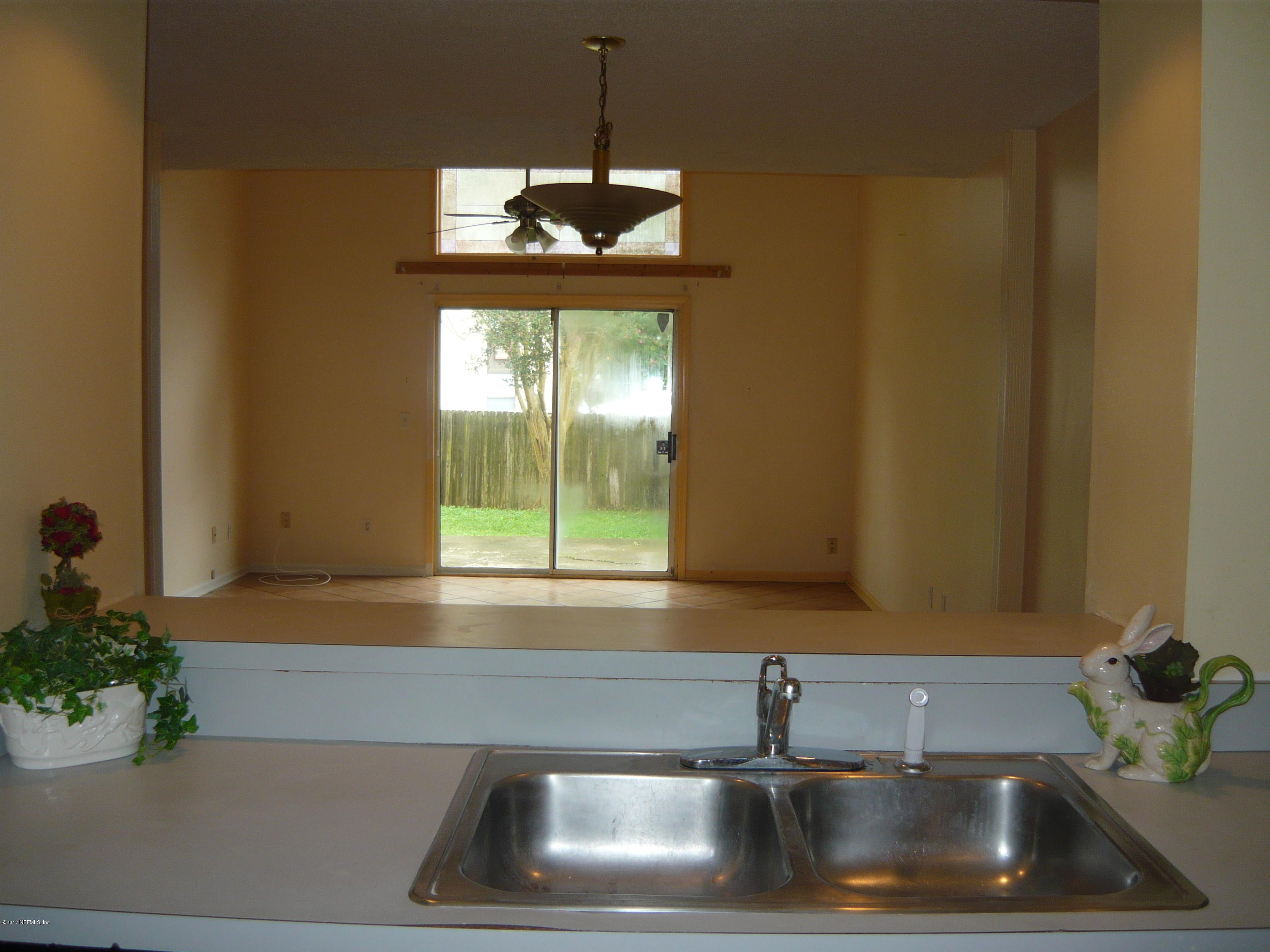 2449 Wattle Tree Road East Jacksonville, FL 32246 - Photo 4 of 22 a kitchen with a sink and chandelier