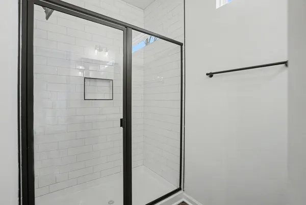 a bathroom with a glass shower door