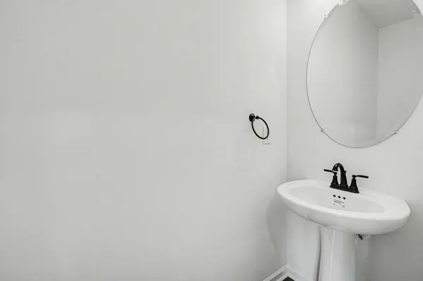 a bathroom with a sink and mirror