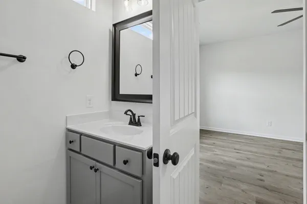 a bathroom with a shower sink and mirror