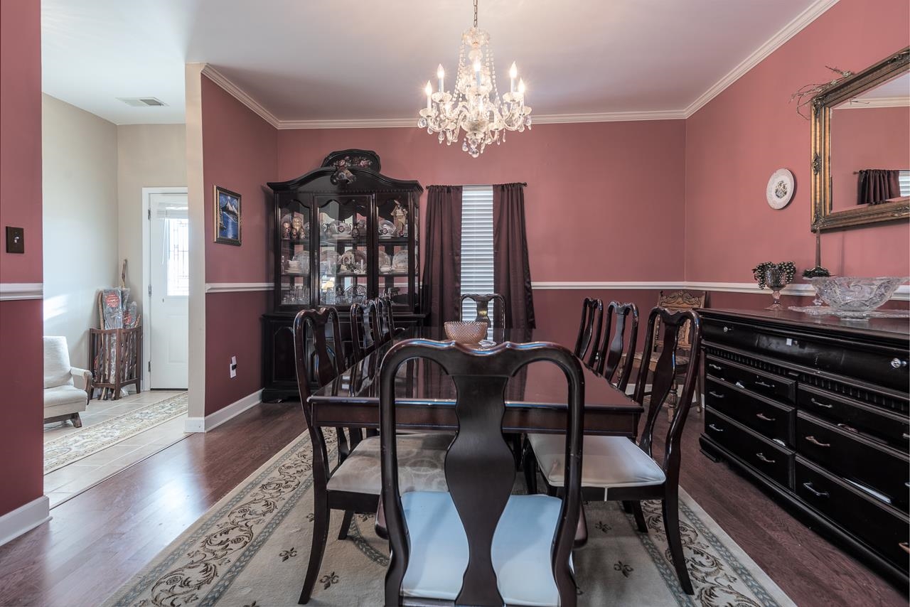 396 Woodview Road Byhalia, MS 38611 - Photo 6 of 23 a view of a dining room with furniture and chandelier