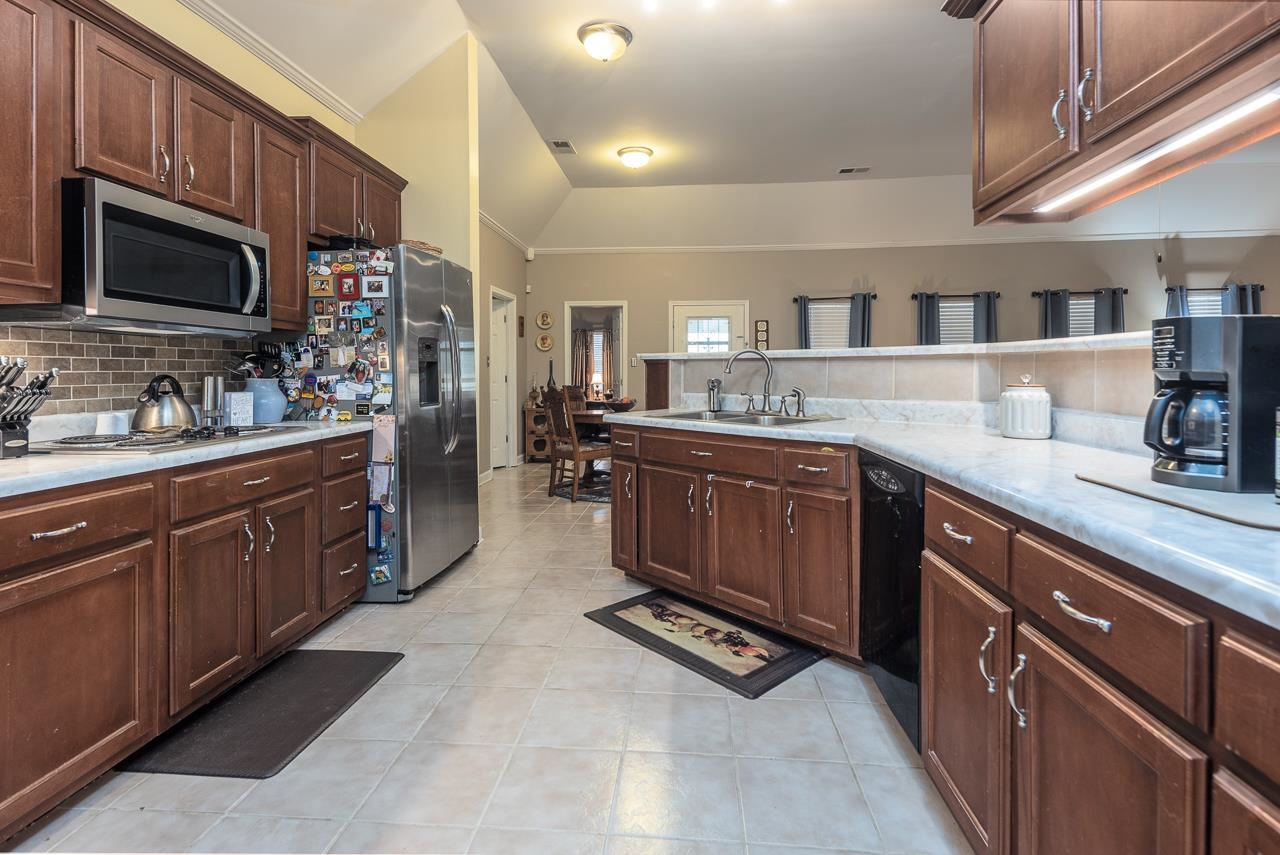 396 Woodview Road Byhalia, MS 38611 - Photo 8 of 23 a kitchen with a sink stove and cabinets