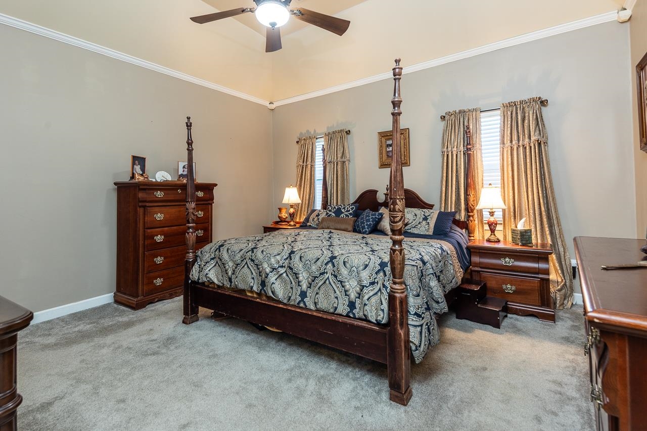 396 Woodview Road Byhalia, MS 38611 - Photo 10 of 23 a bedroom with a bed and a chandelier