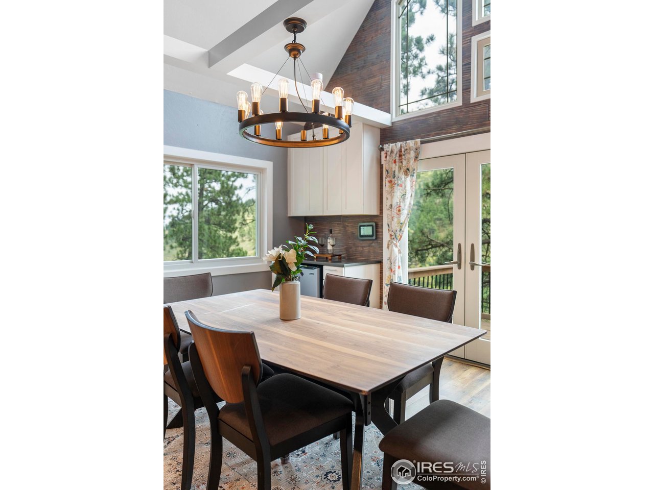 6521 Olde Stage Road Boulder, CO 80302 - Photo 12 of 47 a view of a dining room with furniture a chandelier and large windows