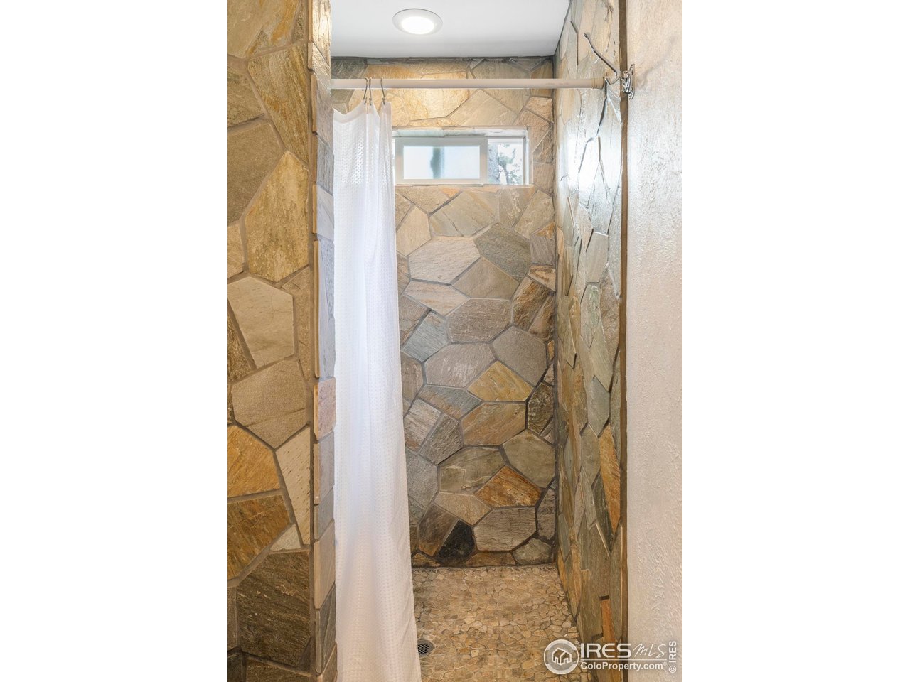 6521 Olde Stage Road Boulder, CO 80302 - Photo 18 of 47 a bathroom with a glass shower door