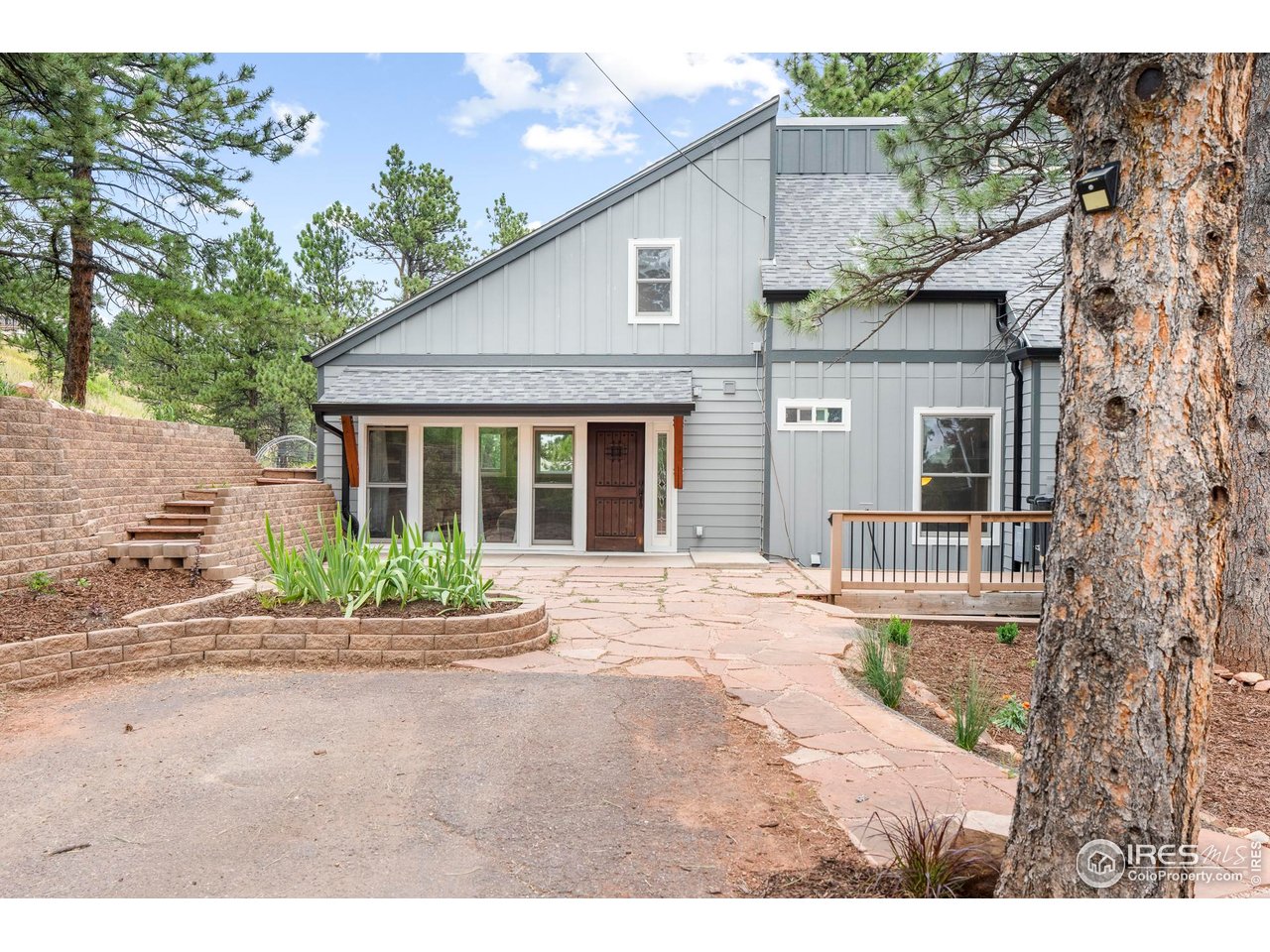 6521 Olde Stage Road Boulder, CO 80302 - Photo 2 of 47 a front view of a house with a garden and patio