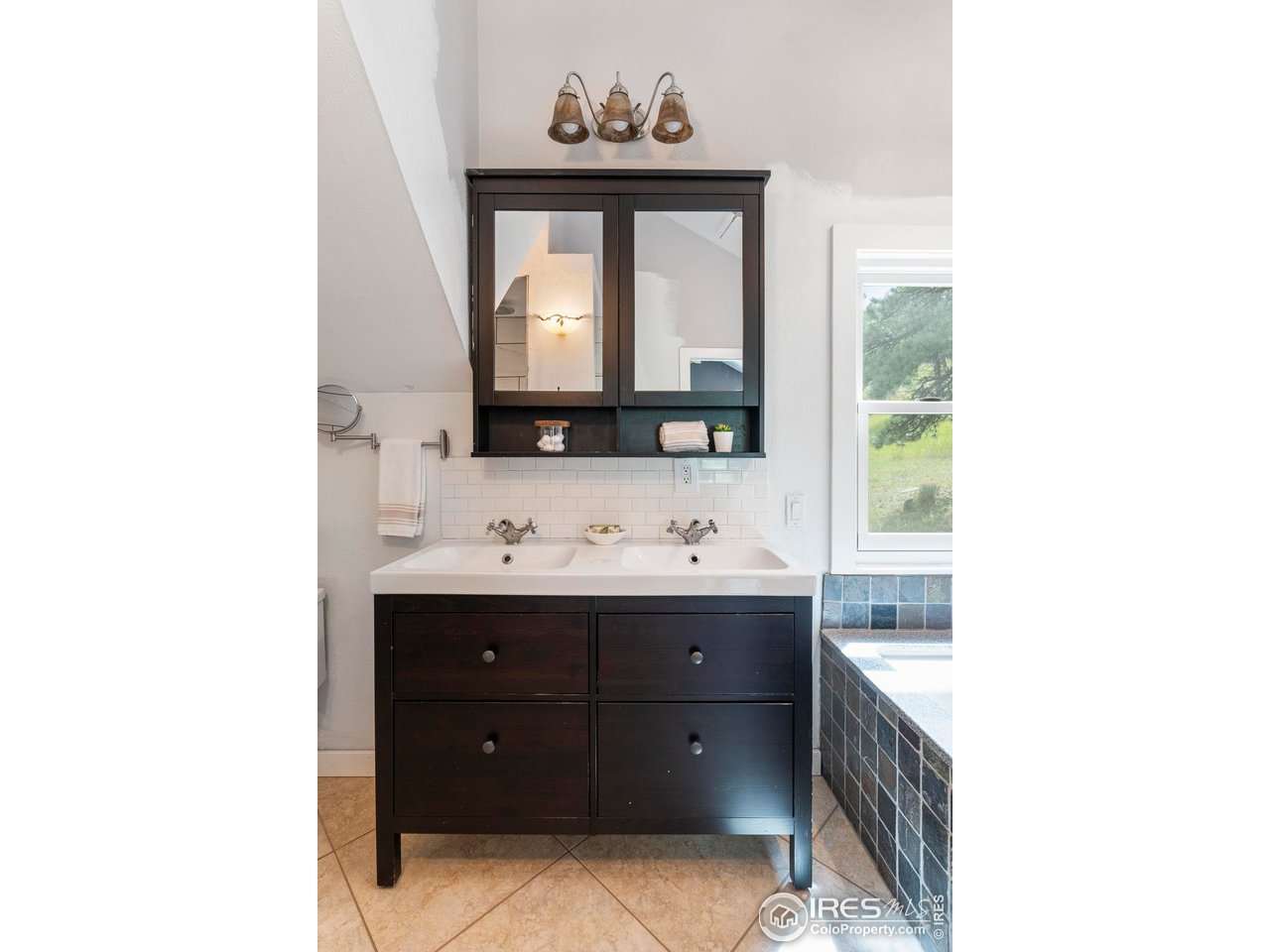 6521 Olde Stage Road Boulder, CO 80302 - Photo 27 of 47 a bathroom with a sink mirror and a bathtub