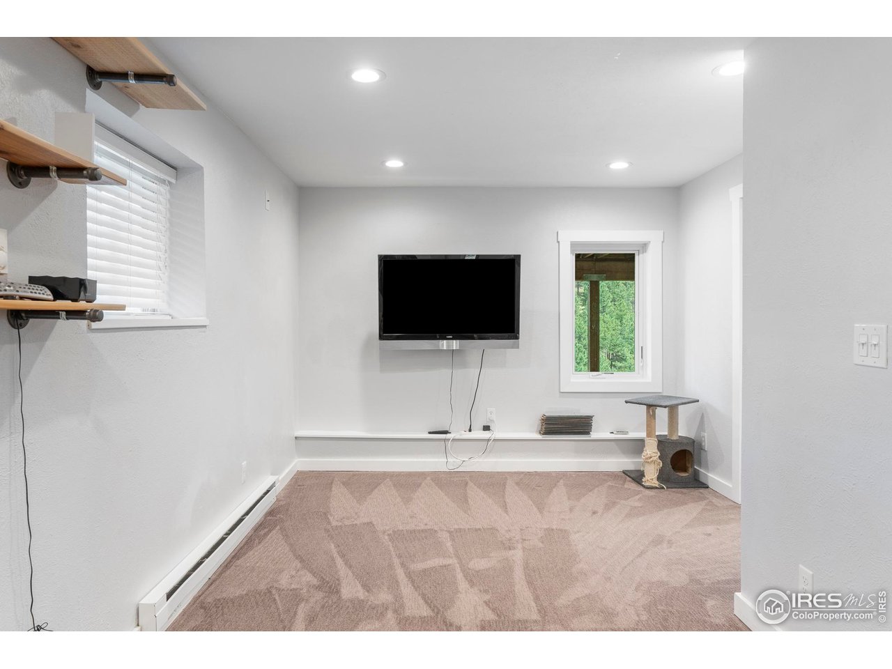 6521 Olde Stage Road Boulder, CO 80302 - Photo 28 of 47 a living room with a flat screen tv and a window