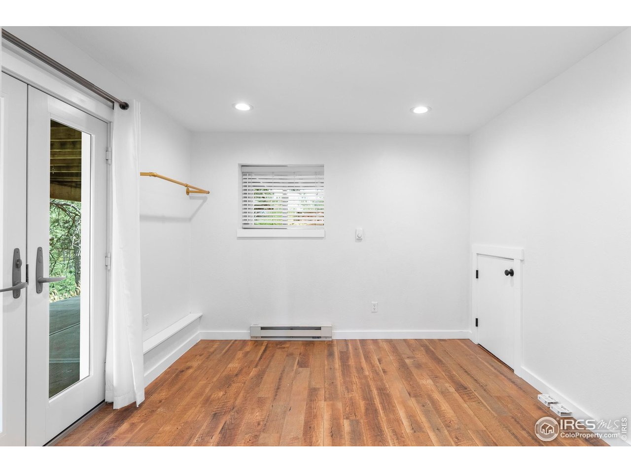 6521 Olde Stage Road Boulder, CO 80302 - Photo 29 of 47 an empty room with wooden floor and windows
