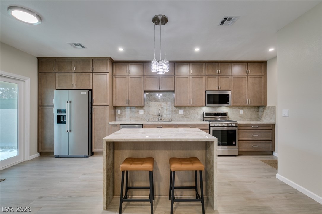 540 Sutters Mill Road Henderson, NV 89014 - Photo 1 of 46 This sleek kitchen features modern appliances, ample storage, and a practical island, perfect for culinary endeavors.