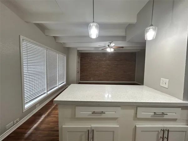 a kitchen with white cabinets sink and stainless steel appliances