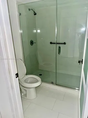 a bathroom with a toilet and a shower