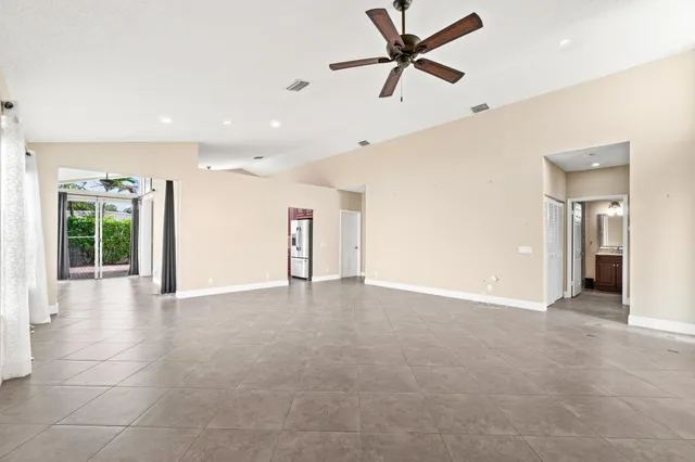 a view of a livingroom with a ceiling fan and window