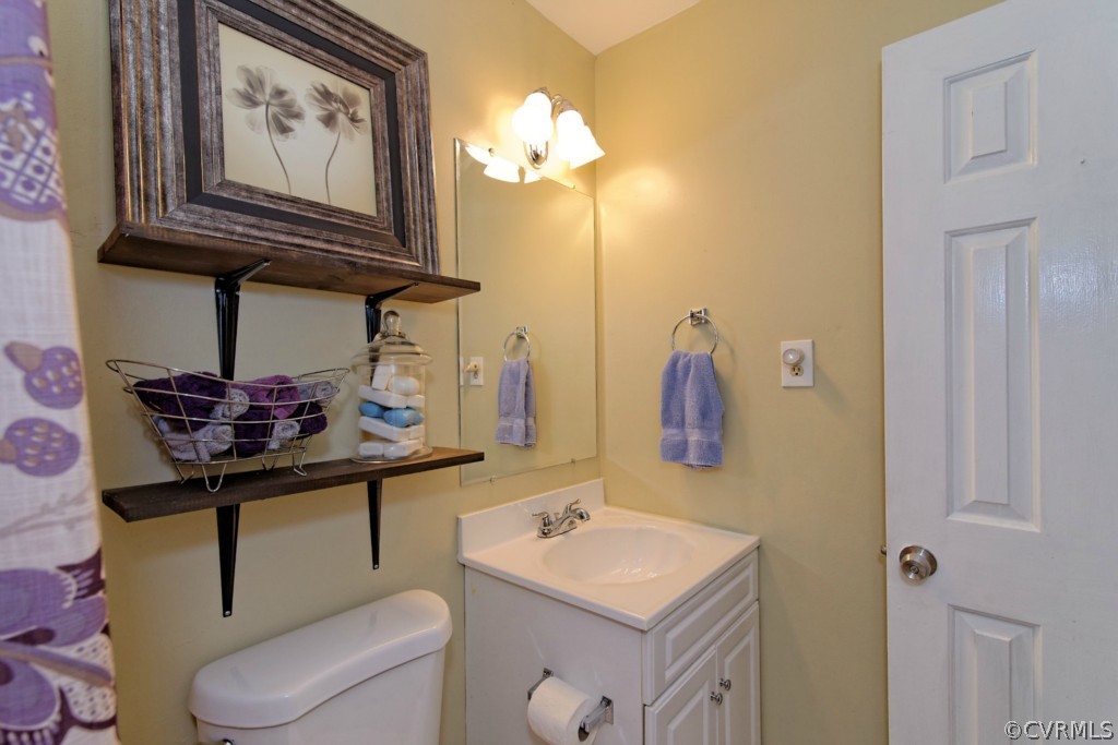 4908 Court Ridge Terrace Midlothian, VA 23112 - Photo 17 of 24 a bathroom with a toilet a sink and mirror