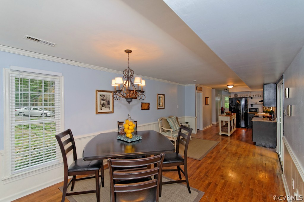 4908 Court Ridge Terrace Midlothian, VA 23112 - Photo 6 of 24 a view of a dining room with furniture a chandelier and wooden floor