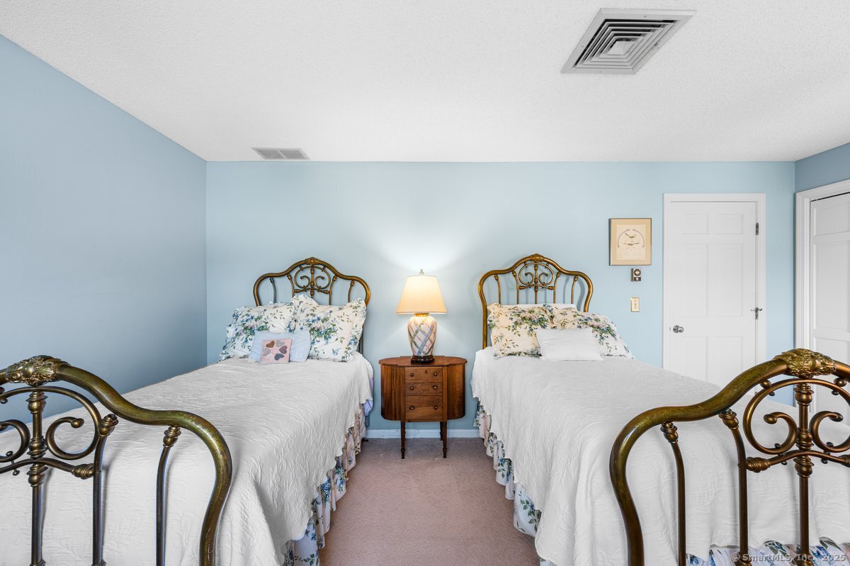 100 Dudley Avenue, Unit H43 Old Saybrook, CT 06475 - Photo 20 of 35 a bedroom with a bed and a painting on the wall