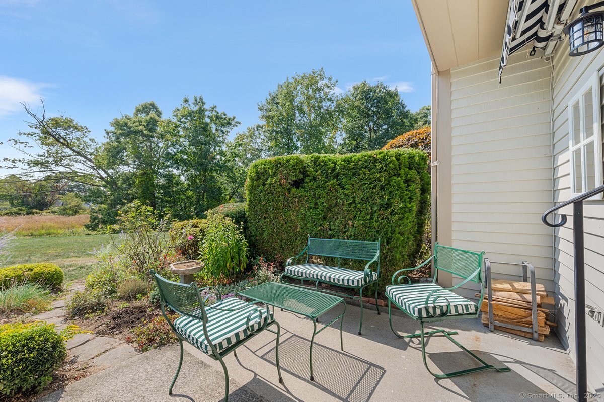 100 Dudley Avenue, Unit H43 Old Saybrook, CT 06475 - Photo 26 of 35 a view of a chairs and table in the balcony