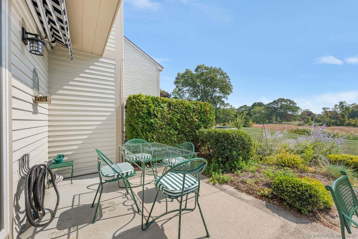 100 Dudley Avenue, Unit H43 Old Saybrook, CT 06475 - Photo 27 of 35 a view of a chairs and table in patio