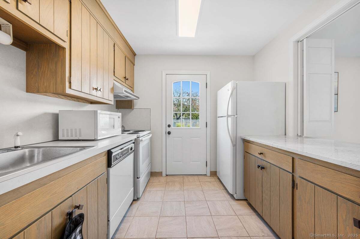 100 Dudley Avenue, Unit H43 Old Saybrook, CT 06475 - Photo 29 of 35 a kitchen with granite countertop a sink stove and refrigerator