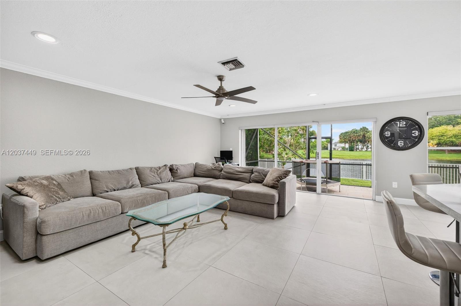 17488 Southwest 28th Court Miramar, FL 33029 - Photo 12 of 50 a living room with furniture a large window and a clock