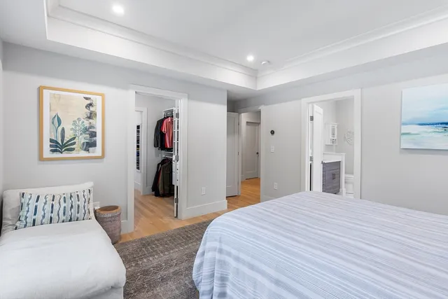 a bedroom with a large bed and dresser