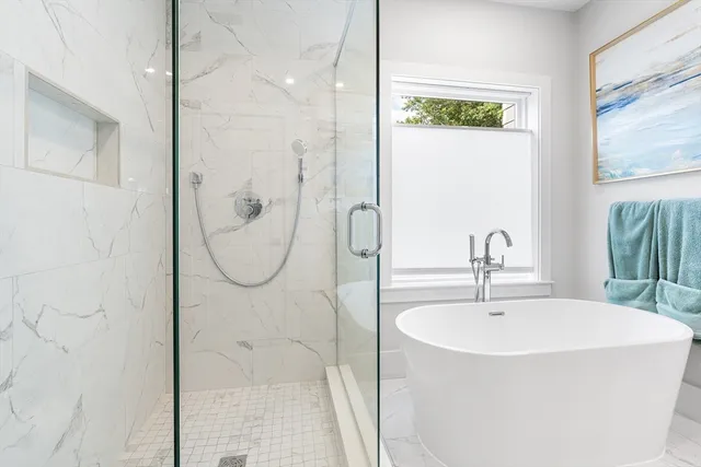 a bathroom with a bathtub and a shower