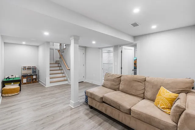a living room with furniture and stairs
