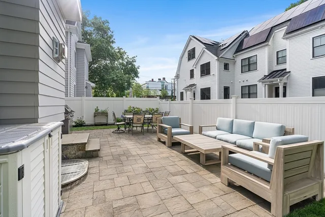 a view of a patio with couple of chairs and couch