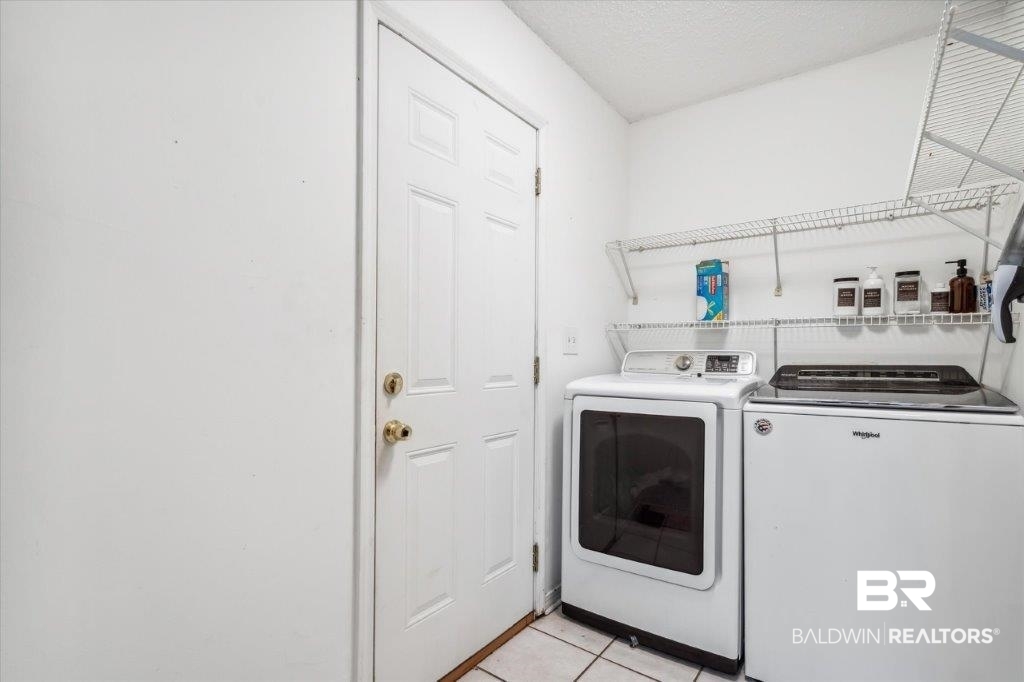 3616 Vista Ridge Drive Mobile, AL 36693 - Photo 13 of 20 Washroom featuring washing machine and clothes dryer and light tile patterned floors