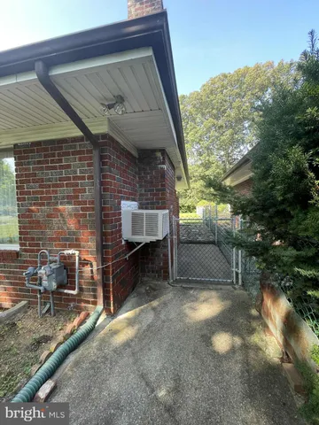 a view of backyard with seating space and trees in the background