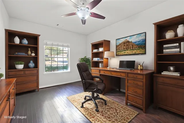 a view of a workspace with furniture and a window
