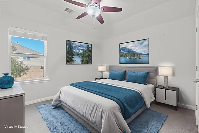 a bedroom with bed painting on the wall and a window