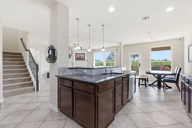 a kitchen with stainless steel appliances granite countertop a stove a sink and a refrigerator